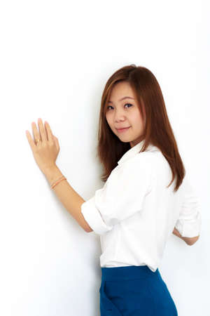 Portrait of a woman on a white wallの写真素材