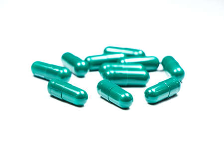 green capsules isolated on white backgroundの写真素材