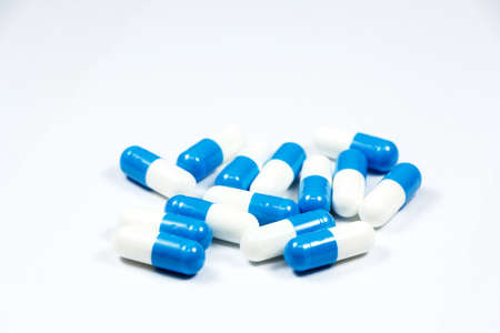 blue and white capsules on white backgroundの写真素材