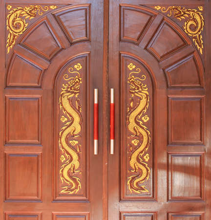 golden dragon decorated on  wood doorの写真素材