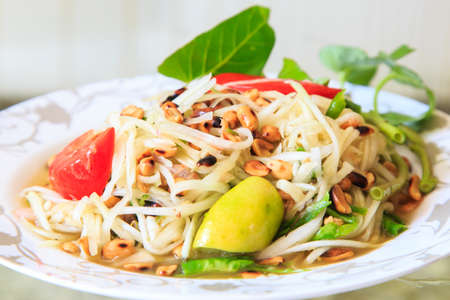 Thai papaya salad served on dishの写真素材