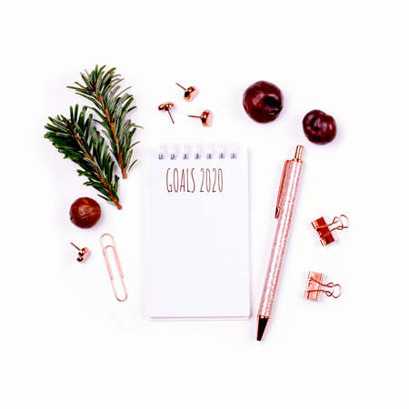 The ring-bound notebook with inscription Goals 2020 on white table with nature objects and stationeries. Minimal flat lay.の写真素材