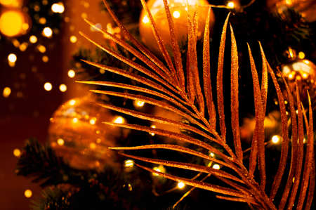 Golden tropical leaves. Bright Christmas tropical decoration.の写真素材
