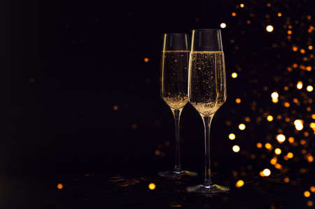 Glasses of champagne with black background and lightsの写真素材