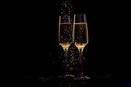 Glasses of champagne with black background and lightsの写真素材