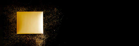 Banner Golden gift box on black background with confettiの写真素材