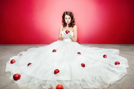 Beautiful bride on red backgroundの写真素材