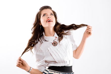 smiling brunette girl looks up,  isolated on white backgroundの写真素材