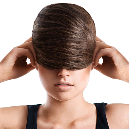Brunette woman with stylish creative hairstyle on white backgroundの写真素材