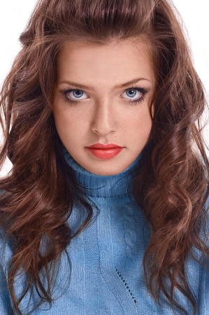 beautiful woman with perfect skin and long curly hair on a white backgroundの写真素材