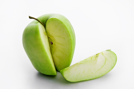 Green juicy apple fruits and slice of apple on white backgroundの写真素材