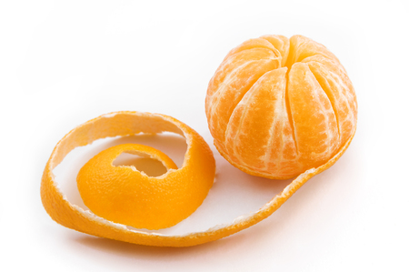 Ripe sweet tangerine with peeled spiral skinの写真素材