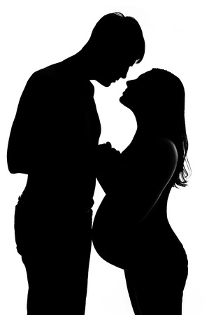 the silhouette of a pregnant woman with her husbandの写真素材
