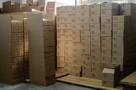 group of stacked cardboard boxes on wooden pallets  in factory warehouseの写真素材