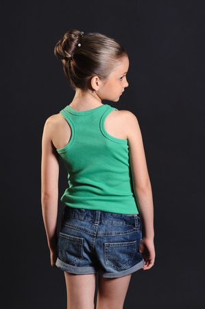 portrait of a beautiful girl from the back over dark backgroundの写真素材