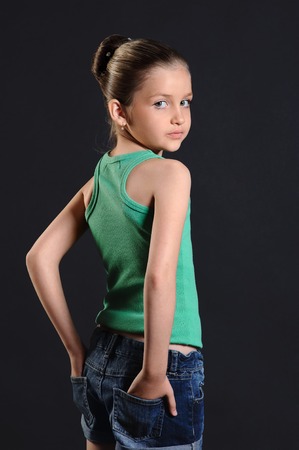 portrait of a cute girl over dark backgroundの写真素材