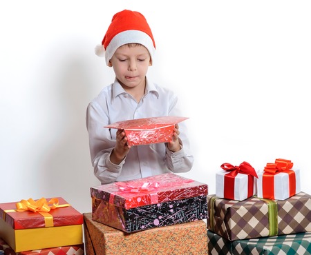 Portrait of adorable boy in Christmas hat with large candyの写真素材