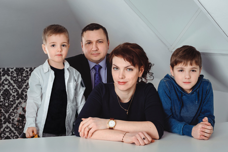 Portrait of loving family with two children indoorsの写真素材