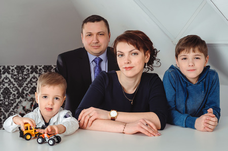portrait of a married couple with two children indoorsの写真素材