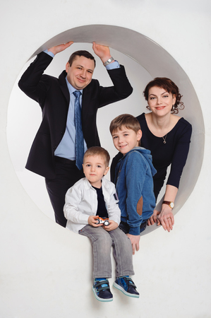 studio portrait of smiling family with two childrenの写真素材