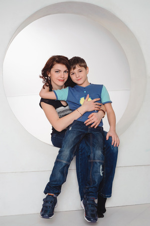 mother hugging her son, happy family, studio portraitの写真素材