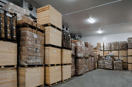 group of stacked cardboard and wooden boxes  in factory warehouseの写真素材