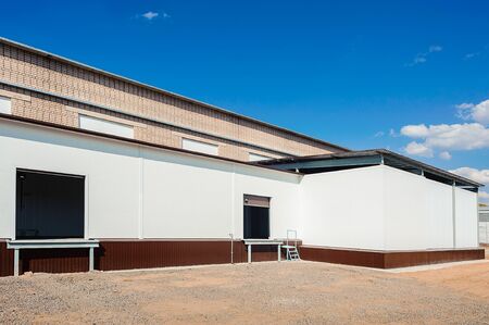 industrial warehouse with office unit with blue sky