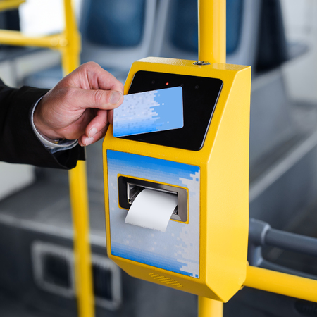 Human hand holding plastic cards. Passenger pays for the fare in public transport. Payment terminal,...