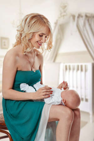 Happy mother and baby girl playing and laughing. Motherhood concept.の写真素材