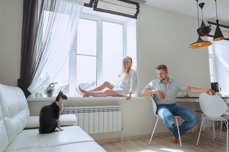 Couple at home with their Sphynx catの写真素材