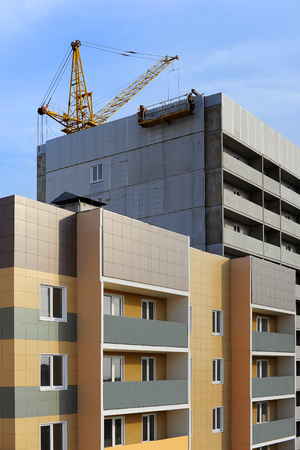 The process of construction of high-rise building. Construction site with craneの写真素材