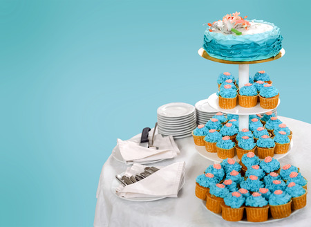 Delicious wedding cake made of cupcakes on blue background with copy space to sideの写真素材