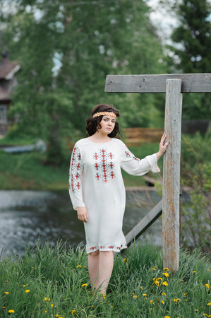 Portrait of a beautiful girl in Slavic clothes. Summertimeの写真素材