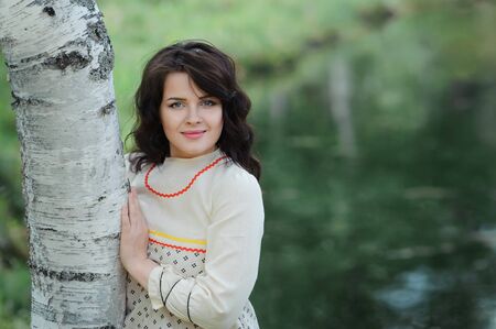 Portrait of a beautiful girl in Slavic clothes. Summertimeの写真素材