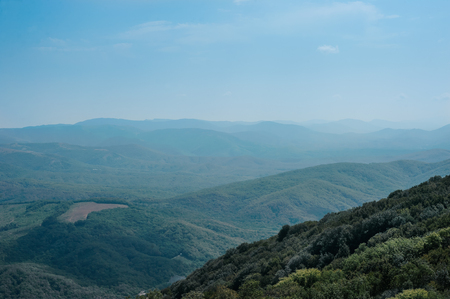 Beautiful view of the Caucasus mountains covered with forest. Natural background