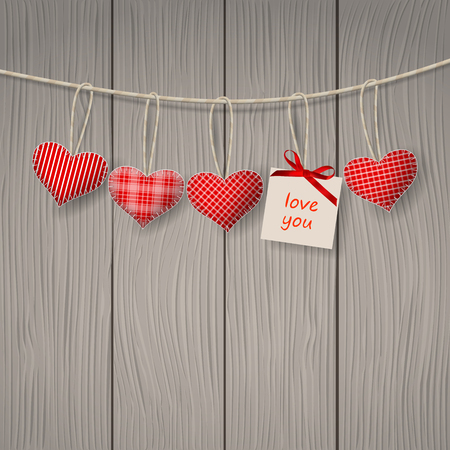 Red hearts hanging over wooden background.のイラスト素材