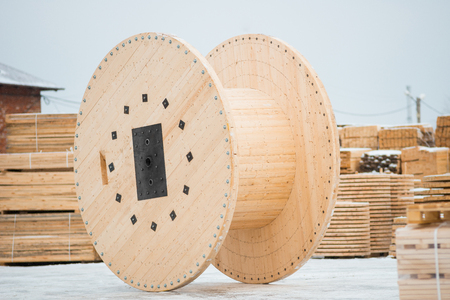 Large empty wooden coil. The new cable drum at the industrial area. Outdoorsの写真素材