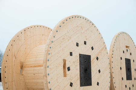 Large empty wooden coils. The new cable drums at the industrial area. Outdoorsの写真素材