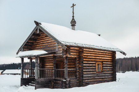 Old rustic wooden house in the countryside. Vintage house in the Russian village. Winter timeの写真素材