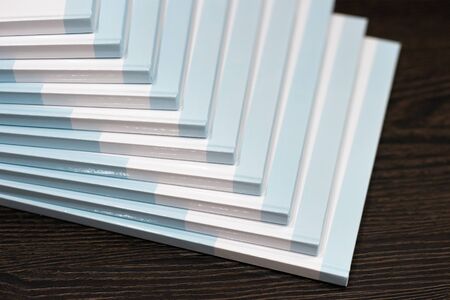 Stack of books with a blue hard cover on wooden background. Composition from booksの写真素材