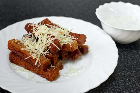 Rye bread croutons with cheese, garlic and sauceの写真素材