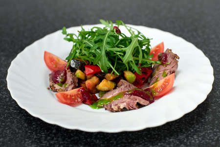 Delicious salad with beef, fresh and grilled vegetables, arugulaの写真素材