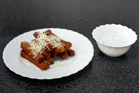 Rye bread croutons with cheese, garlic and sauceの写真素材