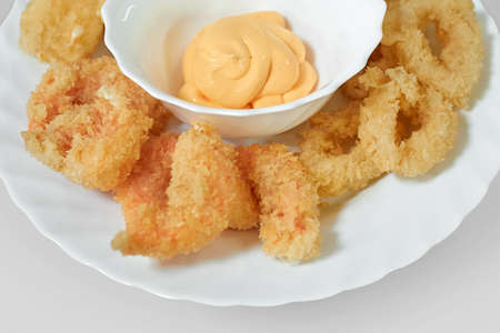 Squid rings and shrimps fried in batter with cheese sauce. Seafood appetizerの写真素材