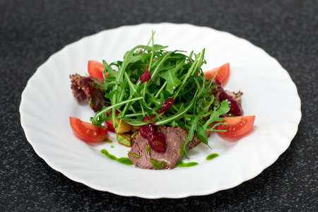 Delicious salad with beef, fresh vegetables, arugulaの写真素材