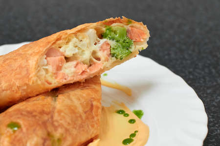 Puff pastry roll stuffed with salmon and broccoli