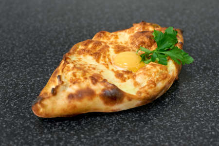 Khachapuri. Traditional Georgian cuisine. Open bread pie with cheese and egg yolk.の写真素材