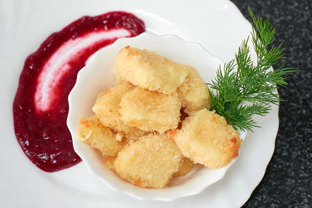 Crispy pieces of cheese fried in batter with sauceの写真素材