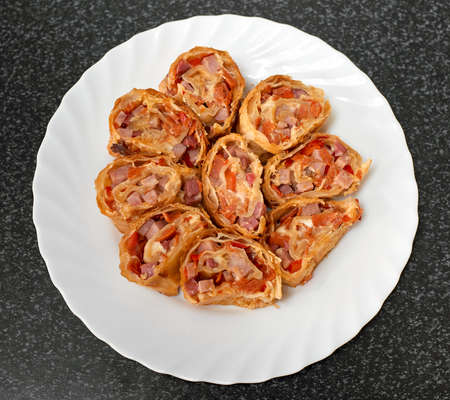 Puff pastry rolls stuffed with ham and red pepper. Top viewの写真素材