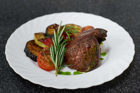 Roasted beef fillet with herbs and grilled vegetables.の写真素材